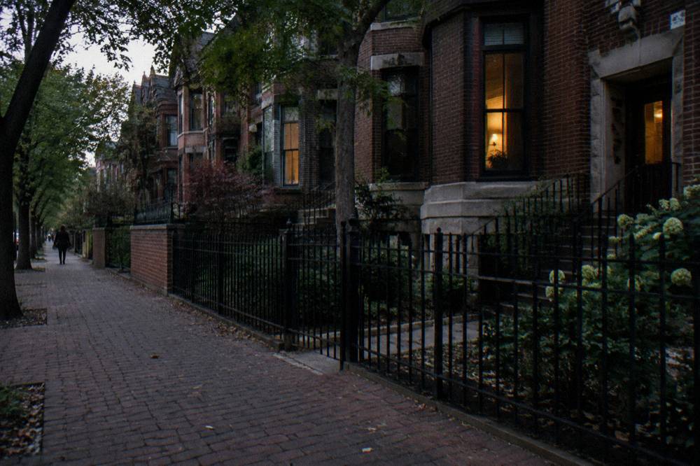 Row of historic brick townhouses on a quiet Chicago street at dusk
