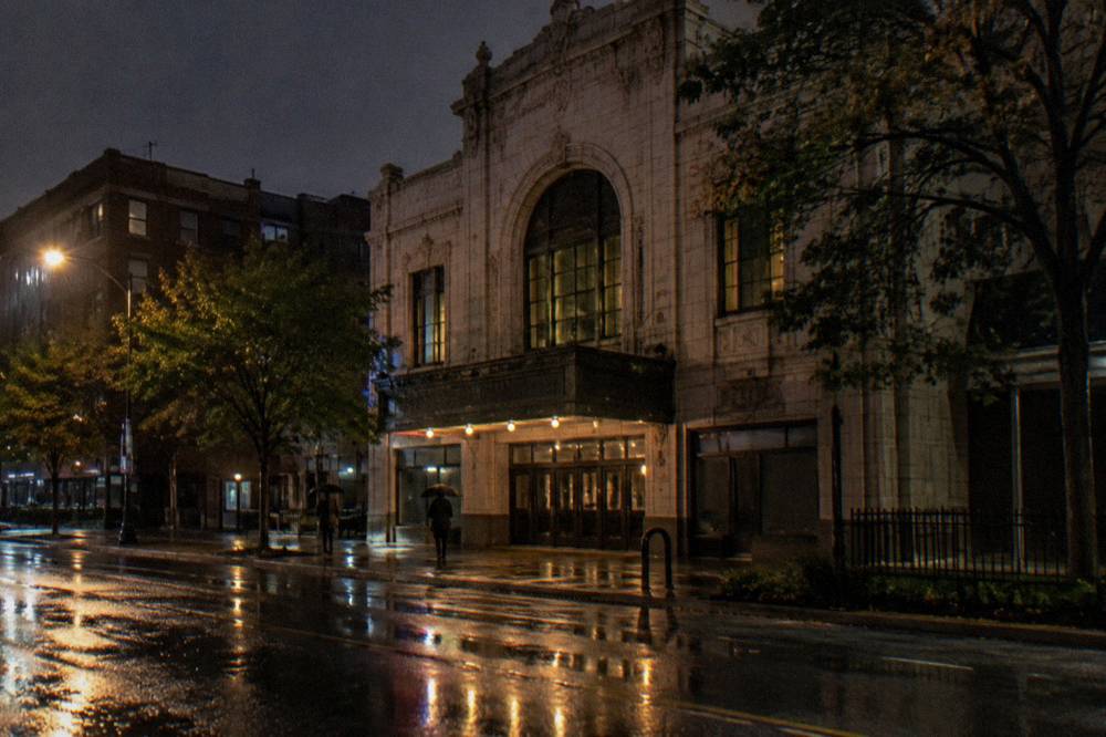 Historic Chicago theater facade at night with marquee lights on a quiet street