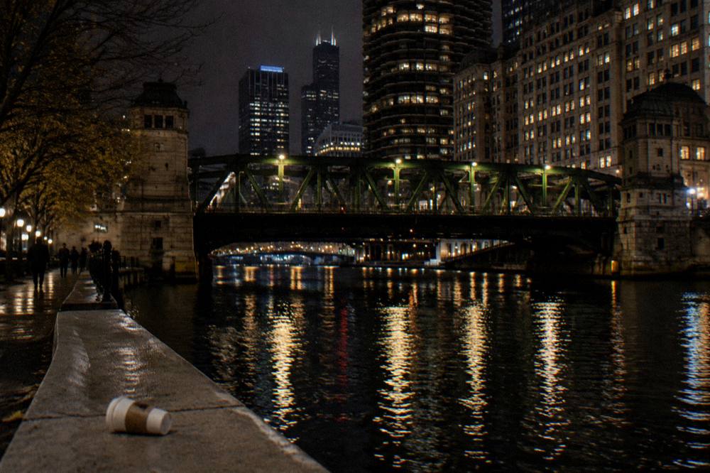 Chicago riverfront at full dark with bridge lights reflected in the water