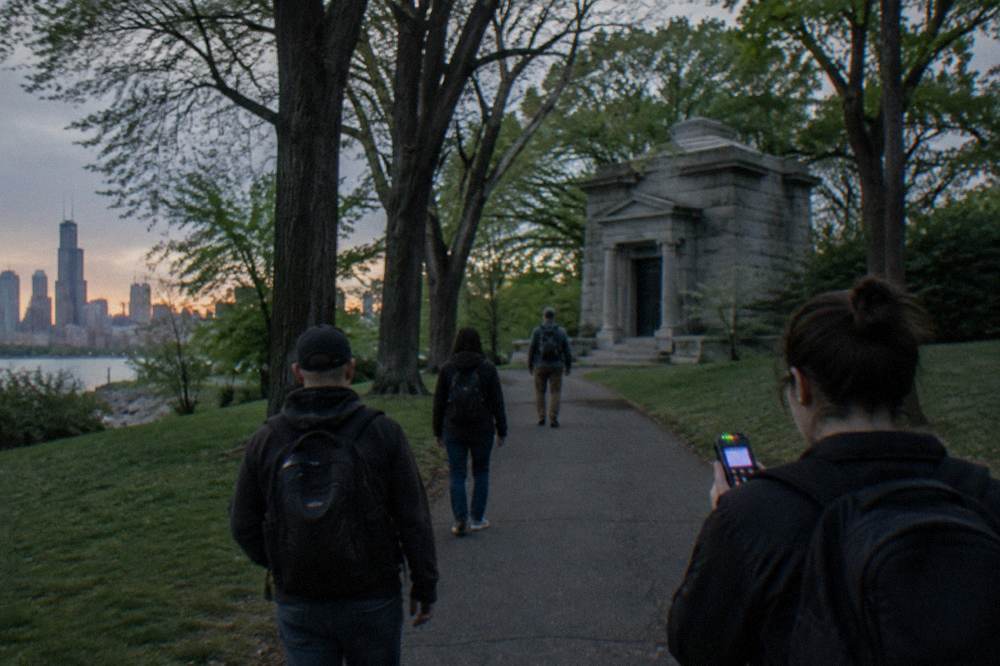 A quiet tree-lined path in Lincoln Park at twilight with distant city skyline